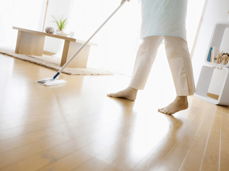 A person cleaning the floor