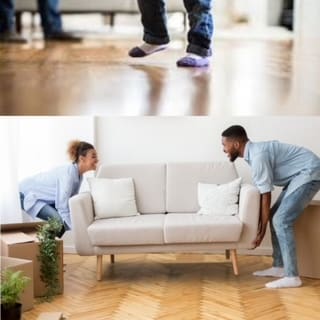 Two people moving a cream colored couch