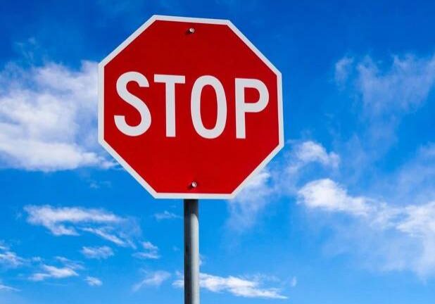 stop sign with blue sky and clouds